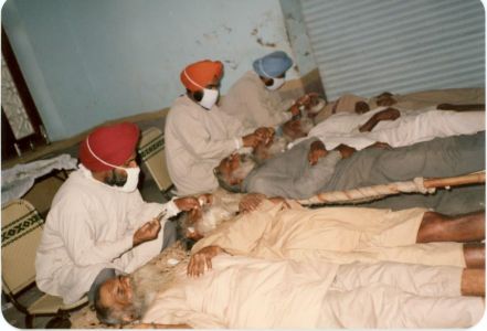 Kang (Middle) Performing Eye Surgery on Villagers, India, 1984. Courtesy of the Kang Family.